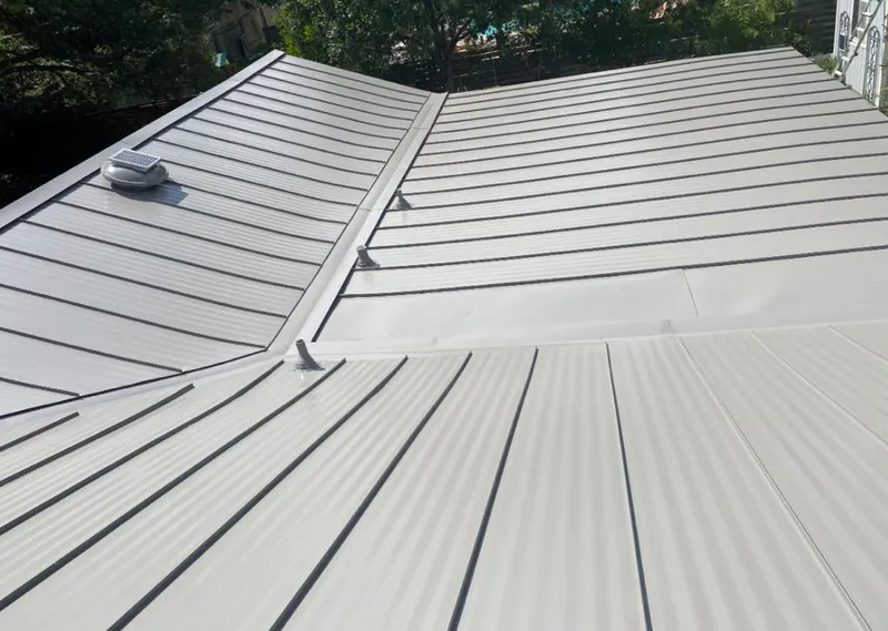 Solar attic fan installed on a metal roof for Roof Ventilation in Gates